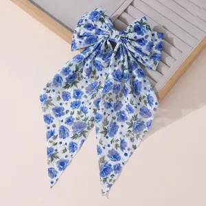 Blue floral chiffon bow hair clip with long tails and spring clip for elegant hairstyles.
