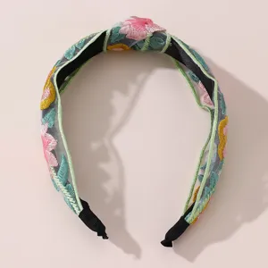 Floral embroidered mesh headband for women, chic wide hair hoop with top knot design.