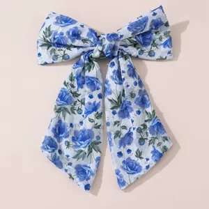 Detailed view of the blue floral chiffon bow hair clip with elegant long tails and soft fabric.