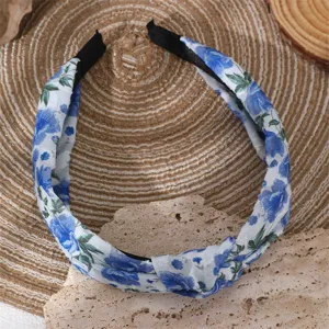 Blue and white floral chiffon knotted headband detail view, elegant fabric hair hoop accessory.