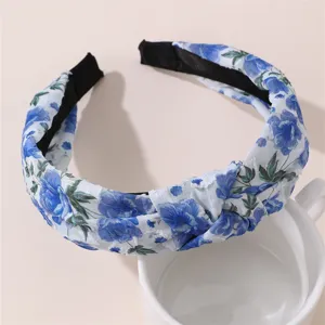 Blue floral print fabric headband detail view, elegant knotted hair accessory for women.