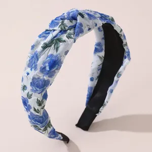 Blue floral knotted headband fabric hair hoop elegant women hair accessory detail view.
