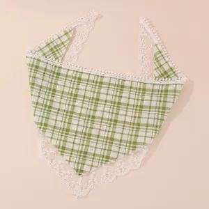 Detailed view of the green plaid hair bandana with delicate white lace and pom-pom trim.