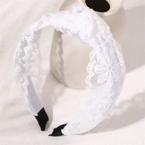 White lace headband with intricate floral pattern and stylish knot design for women and girls.