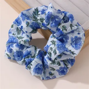 Blue floral chiffon hair scrunchie for women, elegant floral elastic hair band accessory.