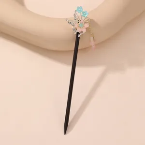 Exquisite antique Chinese hair stick detail with pink and blue floral elements and tassel.