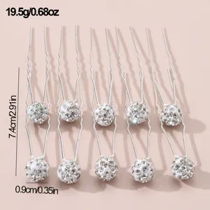 Detailed view of elegant silver rhinestone U-shaped hair pins, sparkling crystal pearl balls.