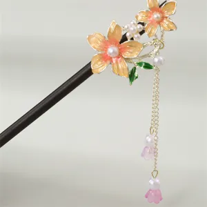 Close up of traditional Chinese hair stick with floral design, pearls and delicate hanging tassels.