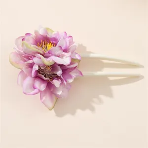 Primo piano dettagliato dell'accessorio per capelli floreale rosa con petali multistrato.
