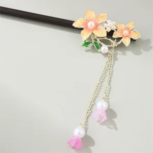Detailed close-up of traditional Chinese retro floral hair stick with enamel flowers and pearls.