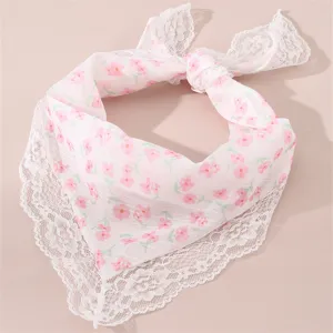 Charming pink floral hair scarf with delicate white lace trim, detailed close-up shot.