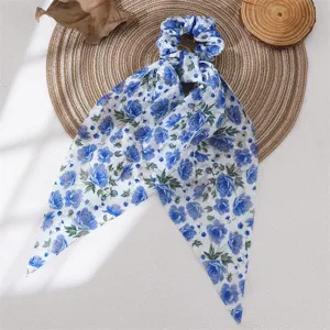 Blue floral print chiffon bow scrunchie detail view, elegant hair accessory for women.