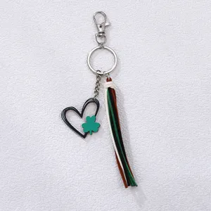 Detail shot of the green shamrock and heart keychain pendant with multi-colored tassel.