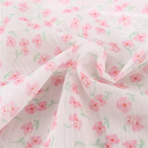 Close-up detail of lightweight fabric with lovely pink floral pattern and soft texture.