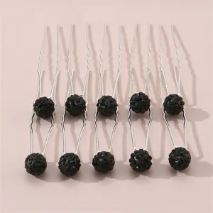 Detailed view of rhinestone U-shaped hair pins, elegant black crystal ball bun hair styling tool.