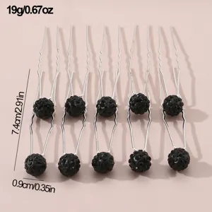 Detailed close-up view of elegant U-shaped hair forks featuring sparkling black crystal balls.