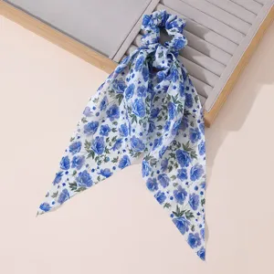 Blue floral chiffon hair scrunchie with long ribbons detail shot on neutral tray.