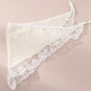 Detail of white lace hair band with floral embroidery and textured plaid design for spring.