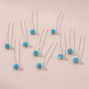 Close-up shot of blue rhinestone crystal ball U-shaped hair pins, elegant styling accessories for women.