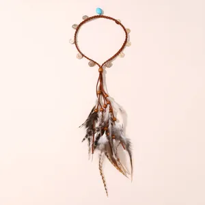 Gros plan detaille du joli bandeau de cheveux boheme en plumes avec laniere et perles en bois.