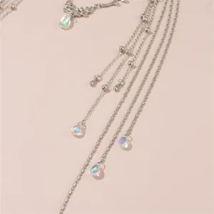 Detailed shot of retro silver multi-strand chain forehead jewelry with iridescent teardrop pendants.