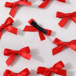 Red ribbon hair bow clips detail close-up, sweet style polyester mini hair accessories.