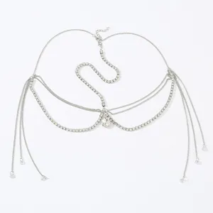 Close-up detail of silver rhinestone forehead chain, sparkling crystal teardrop pendant design.