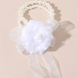 Dettaglio corsage polso perle bianche, rosa in tessuto con fiocco, accessorio matrimonio sposa.
