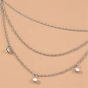 Close-up detail of multi-layer silver chain headpiece with small bells, bohemian boho style.