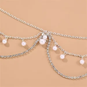 Detailed close-up of crystal rhinestone and pearl forehead chain headpiece boho jewelry.