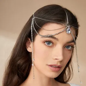 Detailed view of bohemian crystal rhinestone forehead chain, elegant silver hair jewelry.
