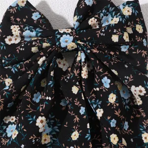 Floral fabric hair bow detail, black sweet hair clip with blue and yellow flower pattern.