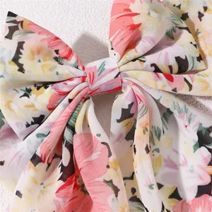 Close up detail of floral chiffon hair bow clip french vintage sweet fabric bow hair accessory