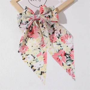Sweet floral fabric bow hair clip with long ribbons for elegant women and girls daily wear.