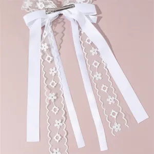 White lace hair clip with bow and long streamers, elegant bridal hair accessory for women.