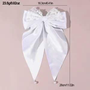 White satin lace bow hair clip with elegant pearls and long ribbons, lightweight design.