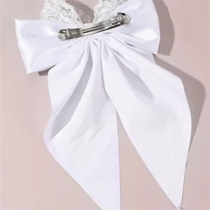 White satin hair bow clip with delicate lace trim, elegant bridal hair accessory for women.