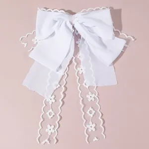 White lace bow hair clip with pearls and long ribbons, elegant wedding bridal hair accessory.
