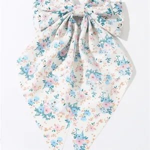 Close-up detail of the French sweet floral fabric bow hair clip with long streamer.