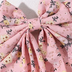 Detailed shot of a sweet pink floral fabric hair bow with elegant floral print and texture.