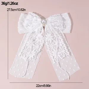 White lace bow hair clip with elegant pearls and long ribbons, ideal for bridal wedding styling.