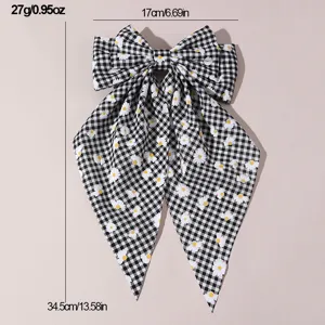 Black and white gingham hair bow with daisy embroidery and long streamers for sweet styles.