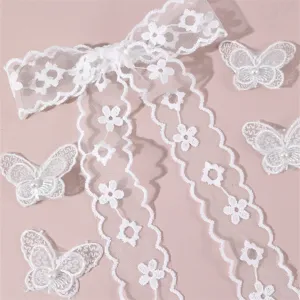 White lace hair bow and butterfly clips set, elegant bridal wedding hair accessories detail.