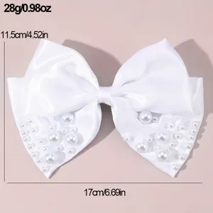 White satin bow hair clip decorated with elegant pearls, perfect bridal hair accessory.