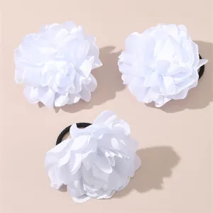 White fabric flower hair tie detail close up, multi-layered floral scrunchie for daily wear.
