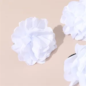 White fabric flower hair accessories detail view, elegant floral design for wedding and daily wear.