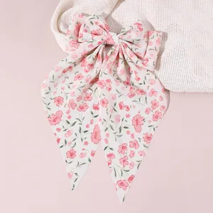 Exquisite floral bow hair clip detail, sweet fabric long streamer design, elegant charm.