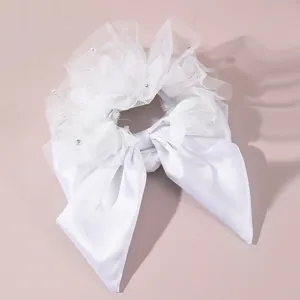 White bridal hair scrunchie with mesh bow and long ribbons, elegant wedding accessory.