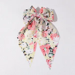 Floral fabric hair bow with long streamers, sweet French style spring clip accessory.