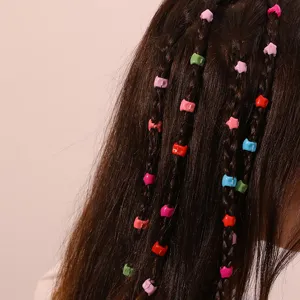 Close-up detail of colorful mini hair clips decorated on braided hair for cute styles.